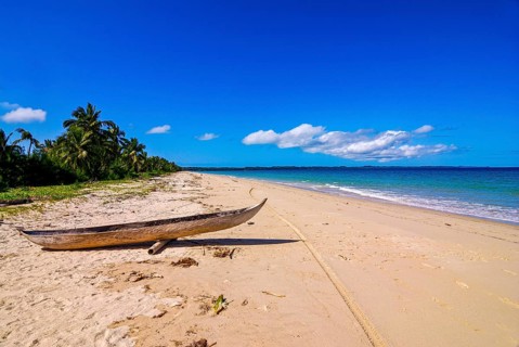 Canoe on a white sand beach on the Island Ile Sainte-Marie although Nosy Boraha