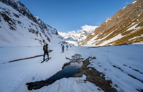 Ski tourers in the Oberbergtal valley on the Oberbergbach stream