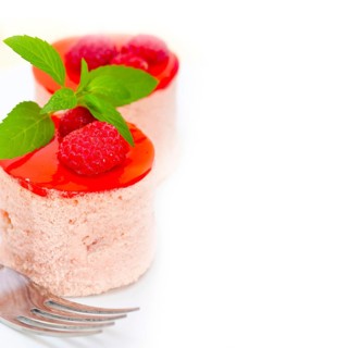 Fresh raspberry cake mousse dessert round shape with mint leaves