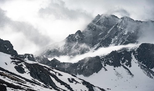 Mountains in winter with clouds and fog