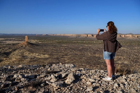 Tourist photographing the Finger Cliff