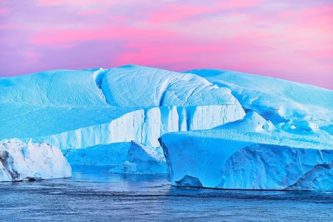Gigantic icebergs in the light of the blue hour