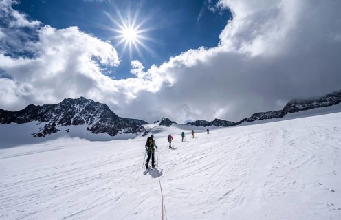 Group of ski tourers ascending on the rope
