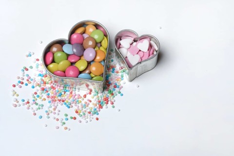 Chocolate lentils and love beads in heart-shaped cookie cutter