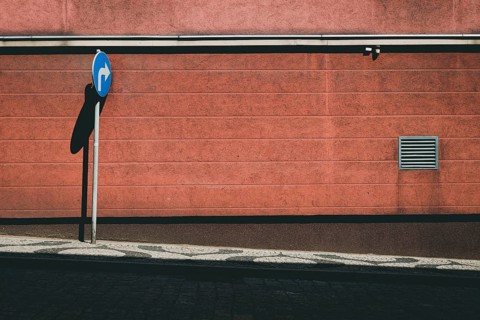 Empty street with blue road sign
