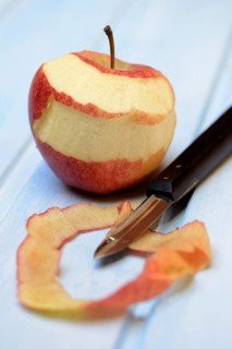 Peeled apple with peeling knife