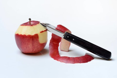 Peeled apple with peeling knife