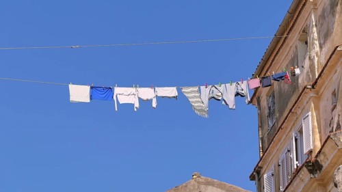 Clothesline with laundry hanging high above Old Town alley