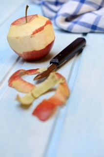 Peeled apple with peeling knife