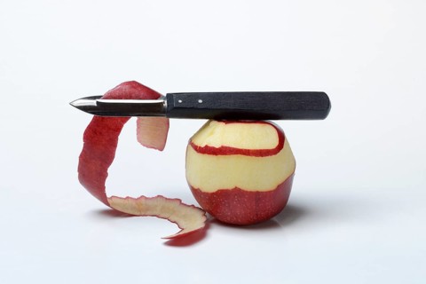 Peeled apple with peeling knife