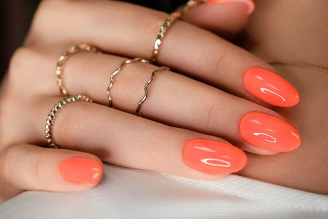 Bright neon manicure on female hands with accessories. Nail design. Beauty hands