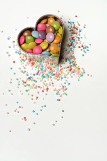 Chocolate lentils and love beads in heart-shaped cookie cutter