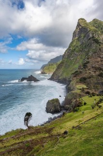 View of steep cliffs and mountains on the coast with sea