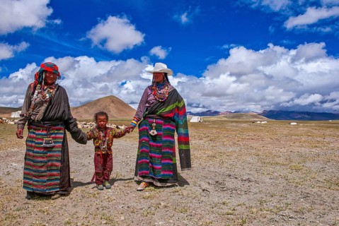 Traditional dressed women with a child