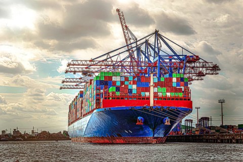 A container ship is loaded with many colourful sea containers in the port of Hamburg. Hamburg
