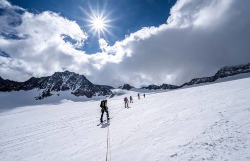 Group of ski tourers ascending on the rope