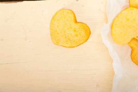 Fresh baked heart shaped shortbread valentine day cookies on a paper wrap