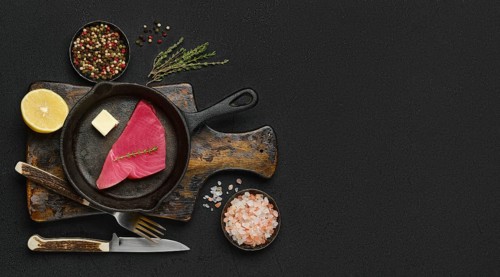 Top view of raw fresh tuna steak ready for frying with place for text