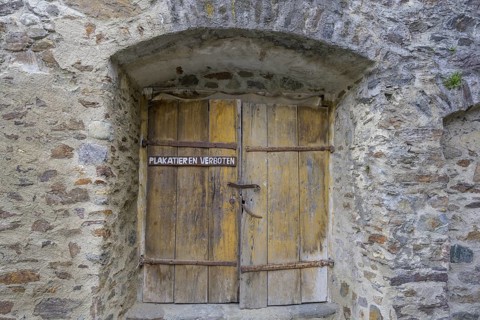Posting Prohibited sign on old wooden door