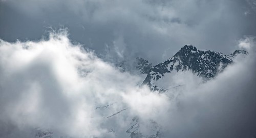 Mountains in winter with clouds and fog