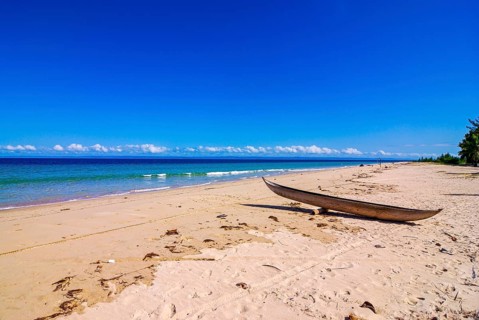 Canoe on a white sand beach on the Island Ile Sainte-Marie although Nosy Boraha