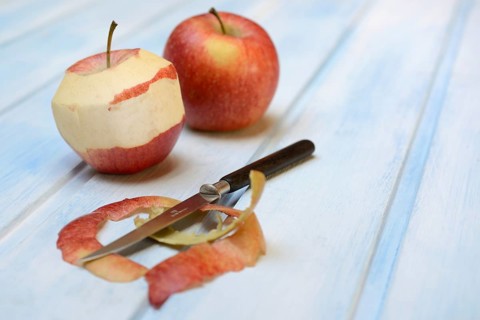 Peeled apple with peeling knife
