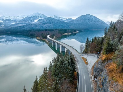 Road with bridge on the water in winter