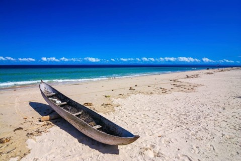 Canoe on a white sand beach on the Island Ile Sainte-Marie although Nosy Boraha