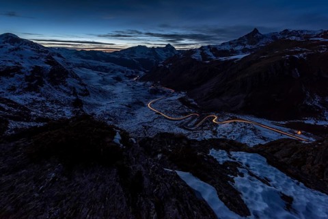 Night photograph with light traces of vehicles on the pass road of the Julier Pass