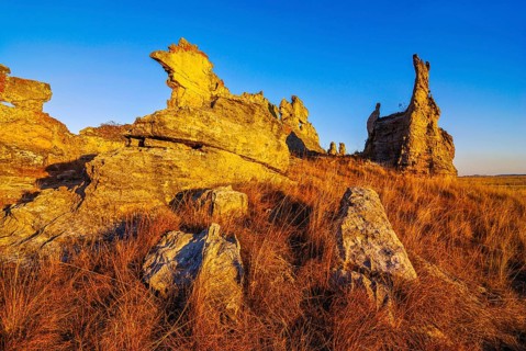 Savannah and huge rock formations at sunset in the Isalo National Park