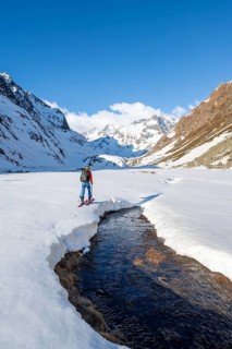 Ski tourers in the Oberbergtal valley on the Oberbergbach stream