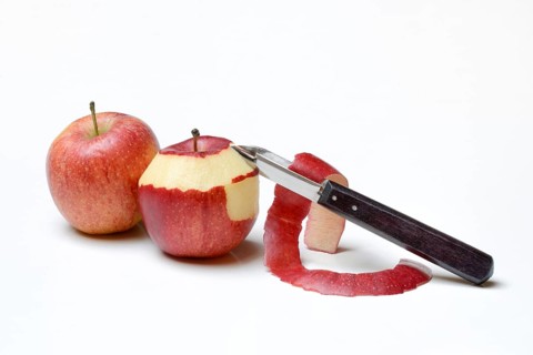 Peeled apple with peeling knife