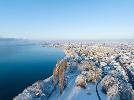Aerial view from Mettnaupark to the town of Radolfzell on Lake Constance in winter