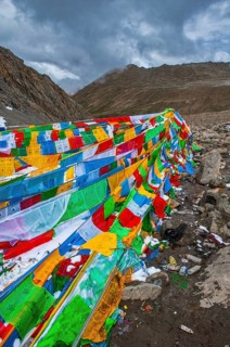 Praying flags and stones on a mountain pass