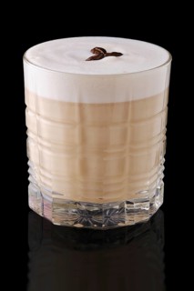 Cappuccino or latte with coffee syrup on black background with reflection