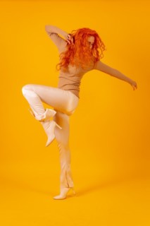 Red-haired woman on a yellow background