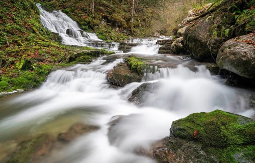 Long exposure waterfall and stream with moss