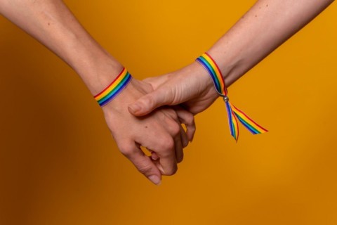Detail of two hands of two women shaking hands with a bracelet