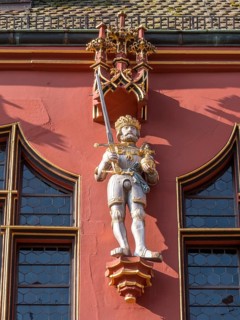 Statue on the facade of the Historic Red Department Store on Muensterplatz