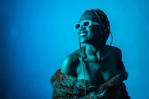 Attractive black ethnic woman with braids with blue led lights