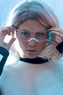 Woman looking with the illuminated futuristic glasses