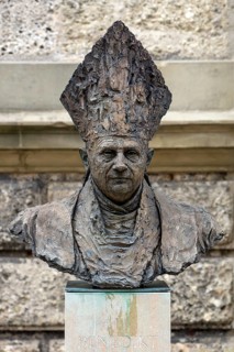 Bust of the German Pope Benedict XVI in front of the parish church Sankt Oswald