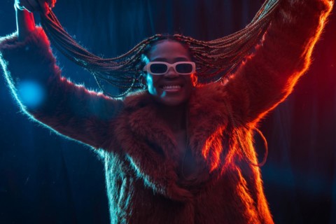 Black ethnic woman with braids with blue and red led lights