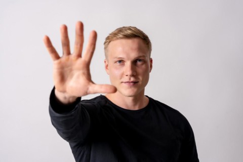 Attractive blonde german model in a black jersey on a white background