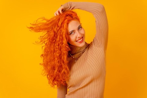 Red-haired woman on a yellow background