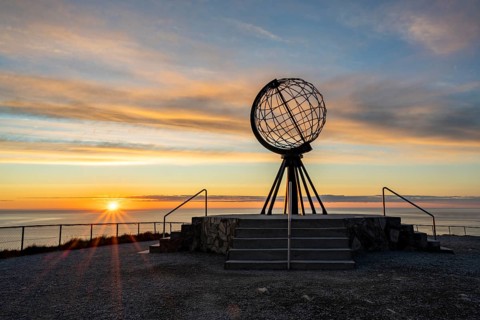 Steel globe at the North Cape under the midnight sun