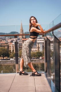 Portrait of a young woman on a hotel terrace looking at the city from above