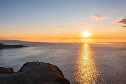 Steel globe at the North Cape under the midnight sun