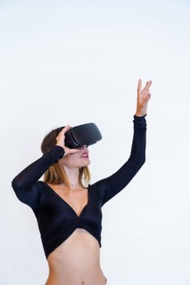 Woman wearing virtual reality goggles on white background