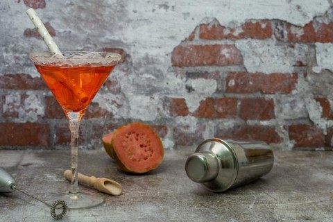 Refreshing squeezed guava cocktail with ice and cocktail shaker